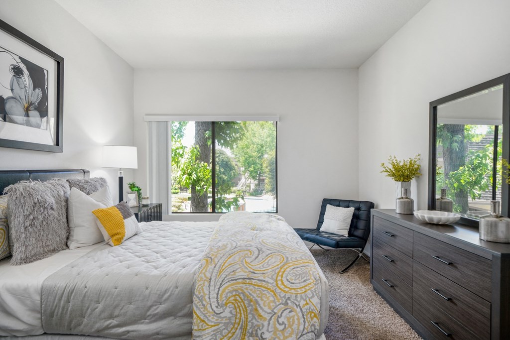 a bedroom with a large bed and a large window
