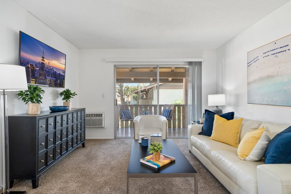 a living room with a white couch and a coffee table