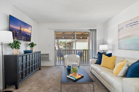 a living room with a white couch and a coffee table