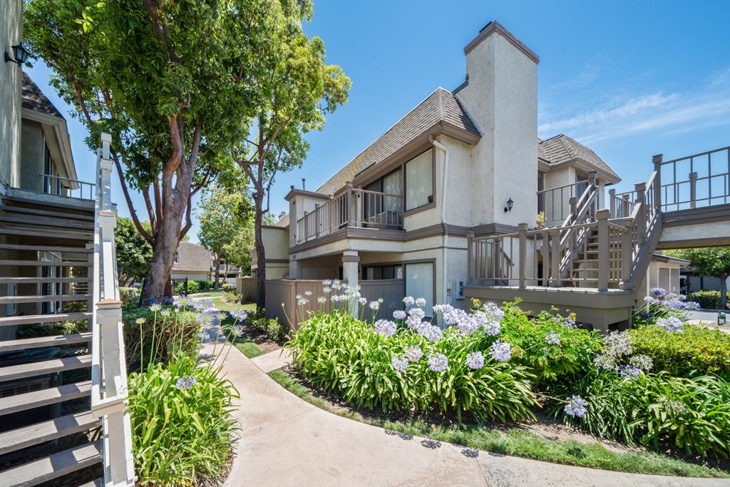 a picture of a house with a garden in front of it