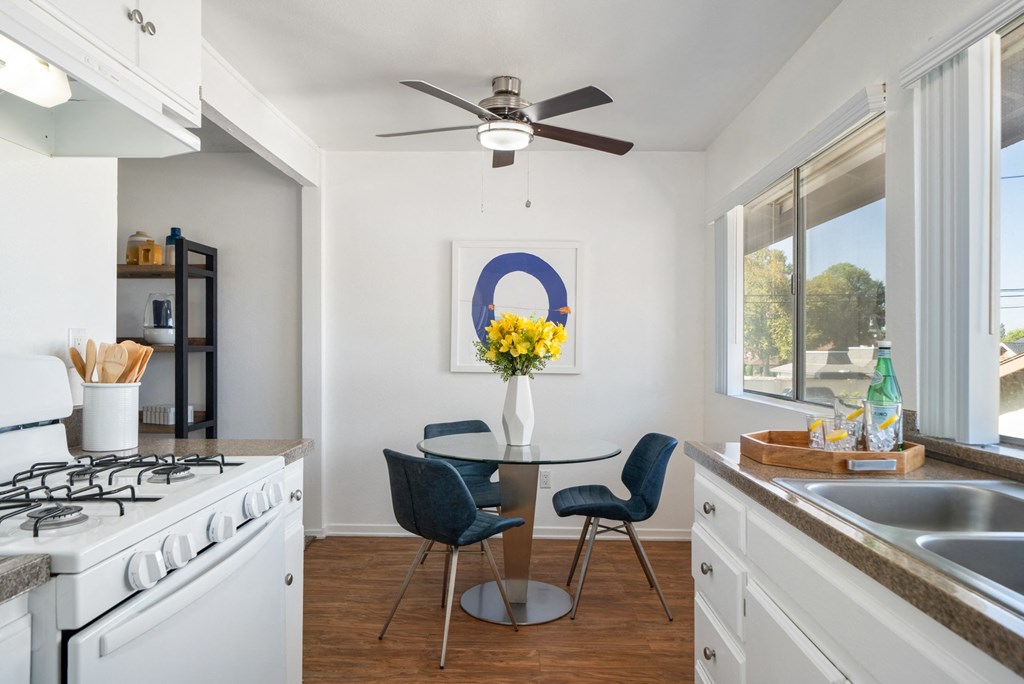 an open kitchen and dining area with a table and chairs