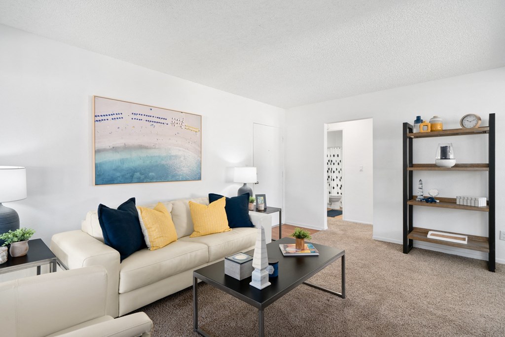 a living room with a white couch and a coffee table