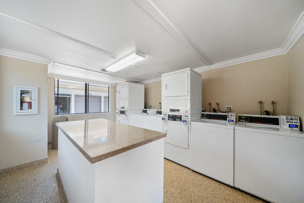 a kitchen with an island and washer and dryer