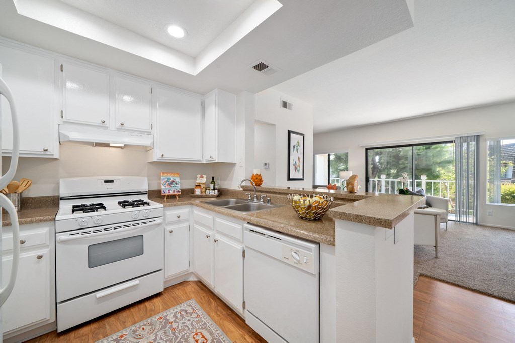 a kitchen with white cabinets and white appliances