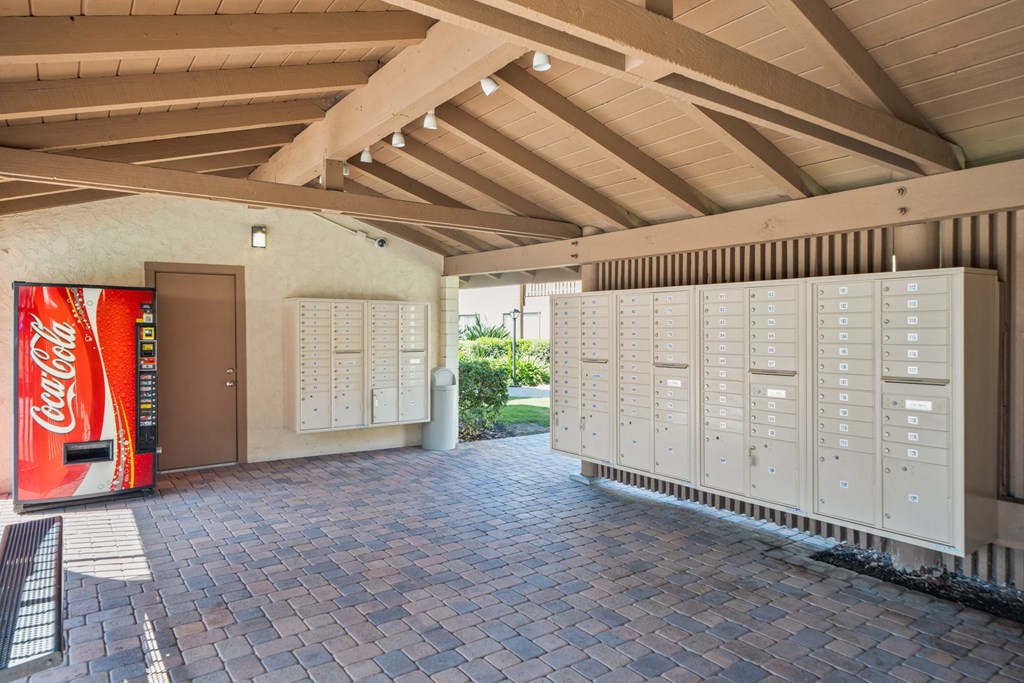 a building with lockers and a coca cola vending machine