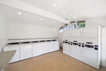 the laundry room has plenty of washes and dryers