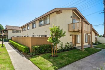 a house with a yard and a sidewalk in front of it