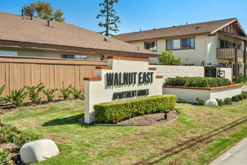 the sign for walnut east in front of a house