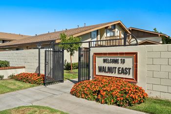 a sign that says welcome to wanted east in front of a building