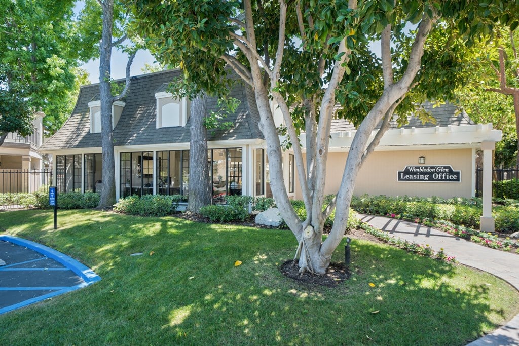a large lawn with trees in front of a building