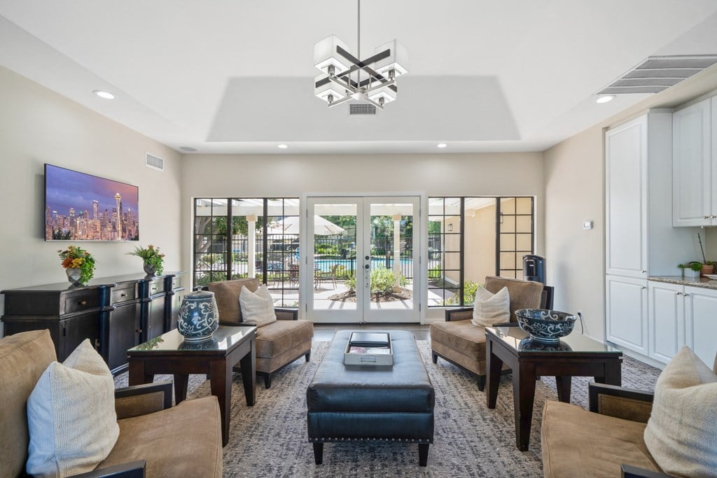 a living room filled with furniture and a large window