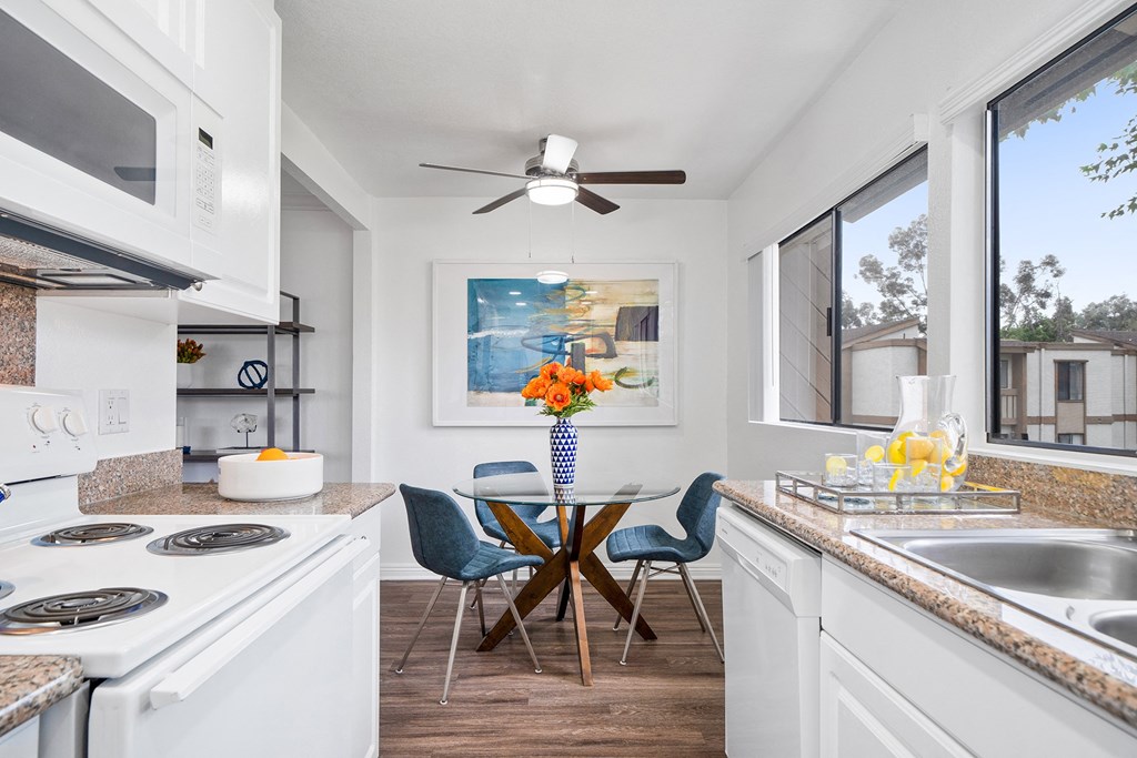 a kitchen and dining area with a table and chairs