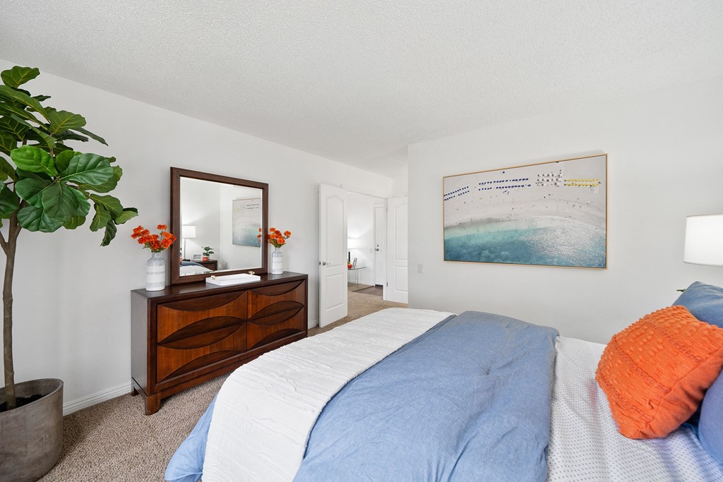 a bedroom with a bed and a dresser