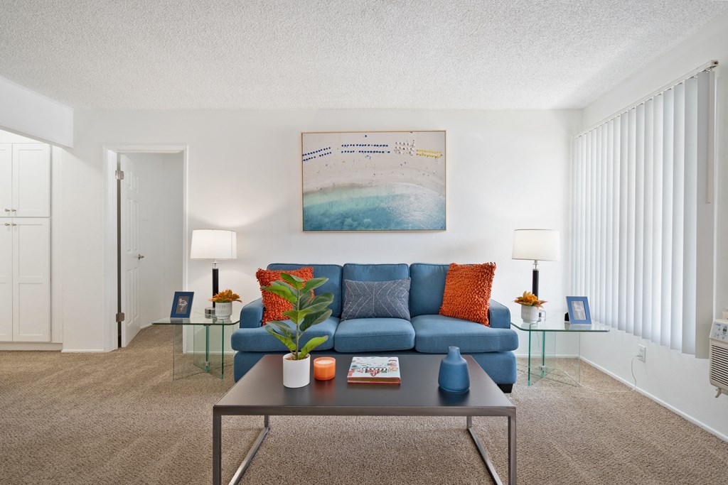 a living room with a blue couch and a coffee table
