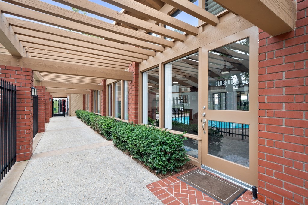 the entrance to a building with a walkway and awning