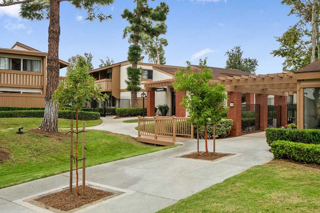 an exterior view of a building with trees and a sidewalk
