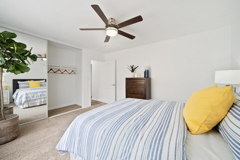 a bedroom with a bed and a ceiling fan