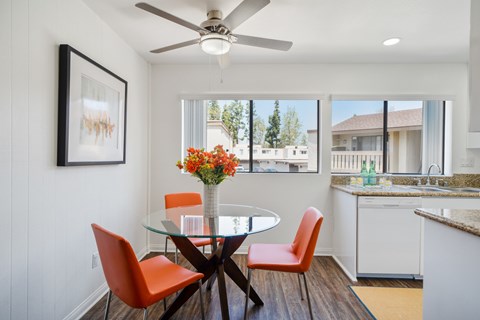A dining room with a glass table and chairs.