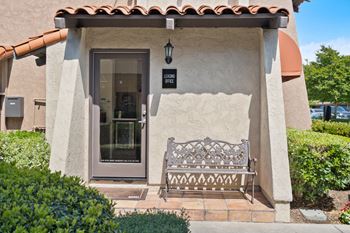 a bench in front of a building with a door