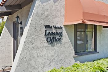 a building with a leasing office sign on the side of it