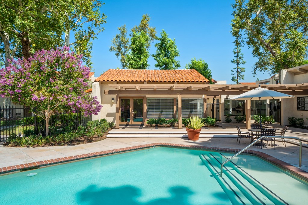 the swimming pool at the backyard of a house with a pool