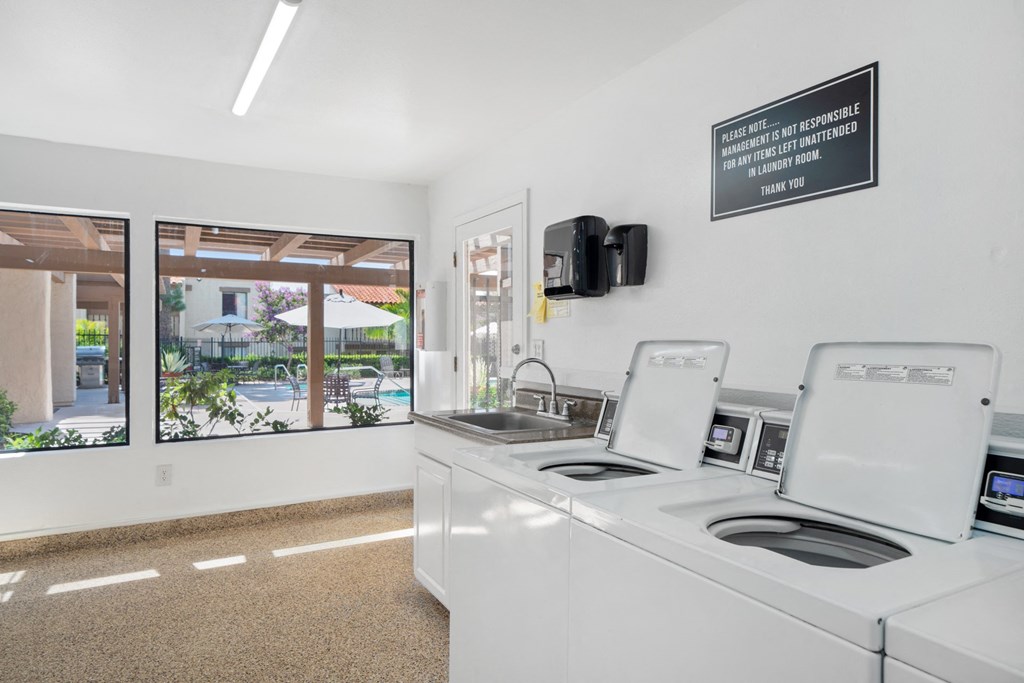 the preserve at ballantyne commons laundry room with washing machines and a sink