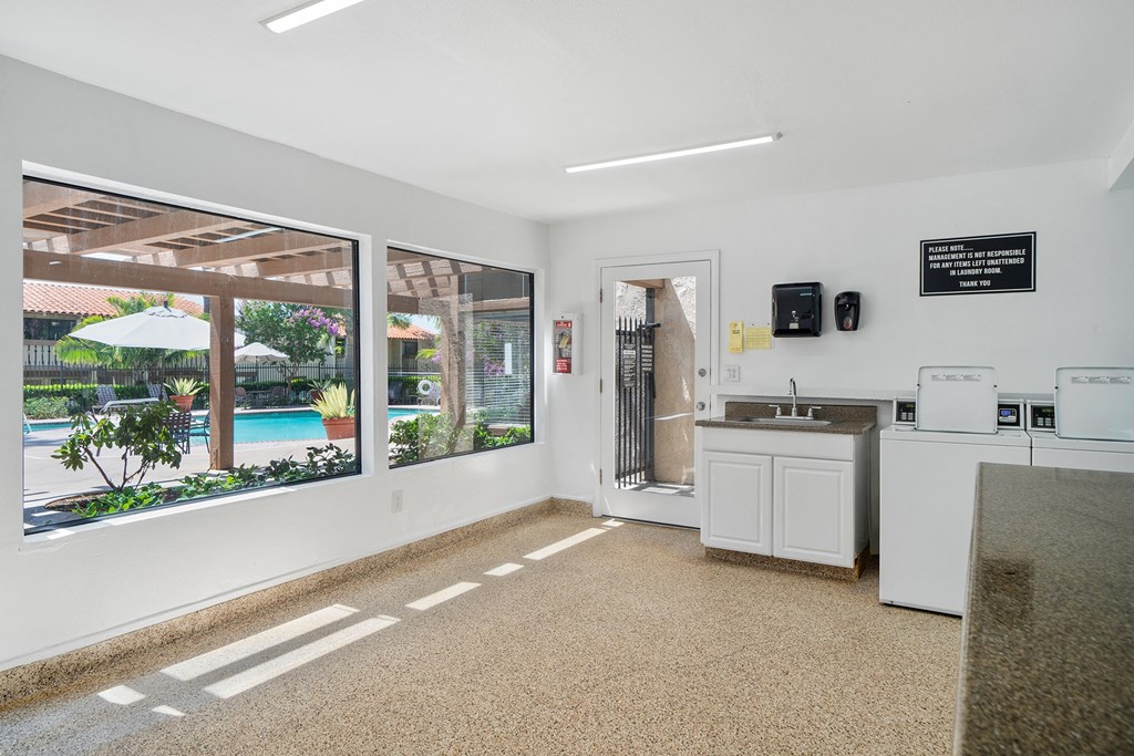 a kitchen with a sink and a window with a pool