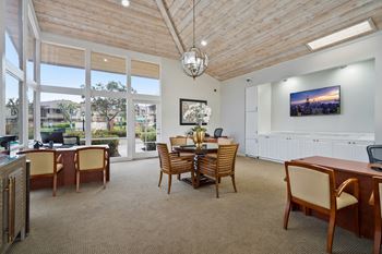a dining room with a table and chairs and a large window