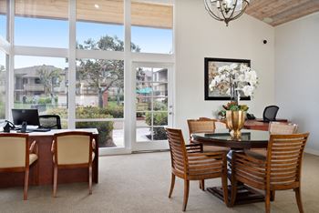 a dining room with a table and chairs and a large window