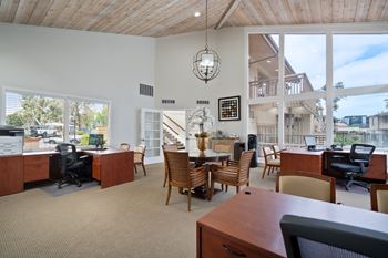 an office with a table and chairs and a large window