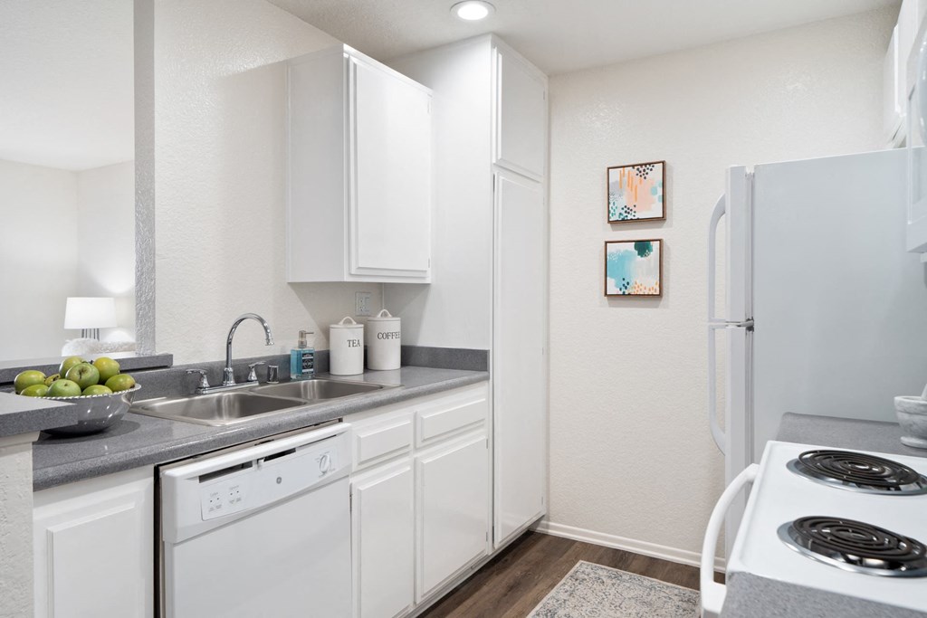 a kitchen with white appliances and a white refrigerator