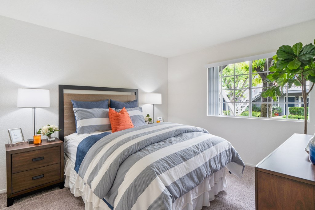 a bedroom with a bed and a window