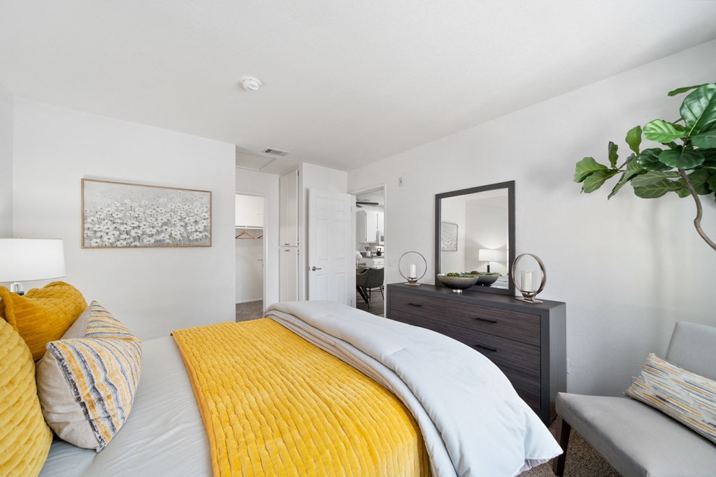 a bedroom with a yellow bed and a yellow blanket