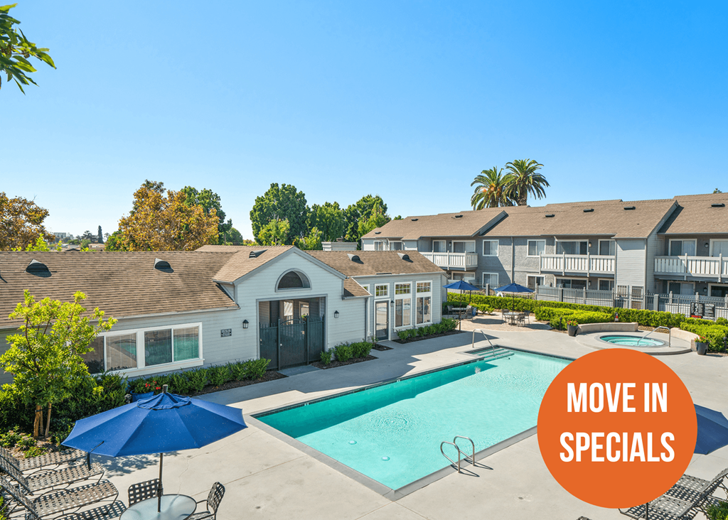 A pool surrounded by chairs and umbrellas with a sign that says "Move in Specials".