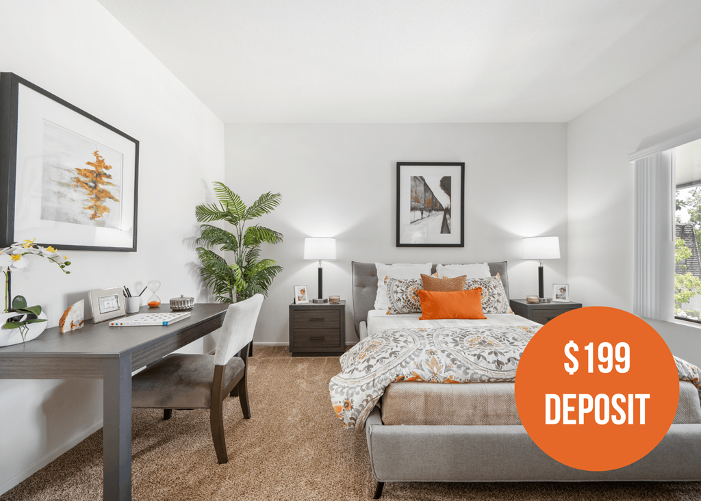 a bedroom with a bed and a desk and a 199 deposit on it