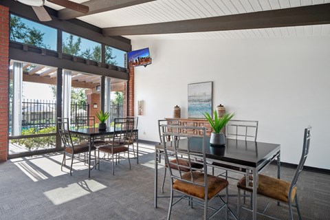 a dining room with a table and chairs and a large window