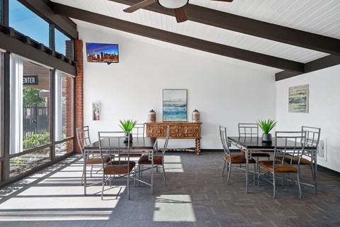 a dining room with tables and chairs and a large window