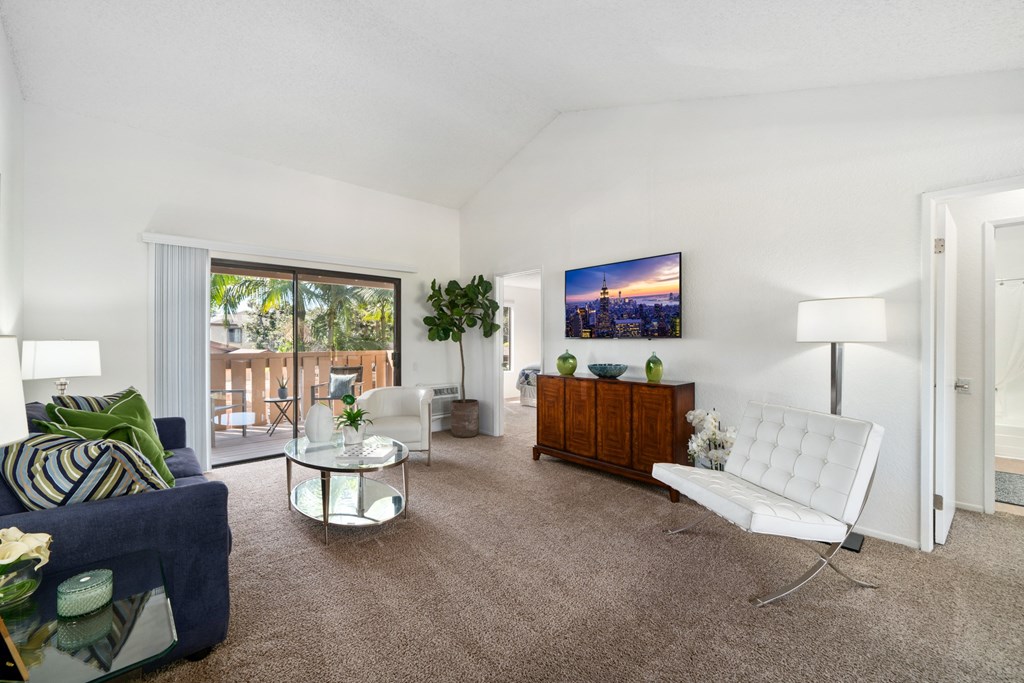 a living room with a white couch and a chair