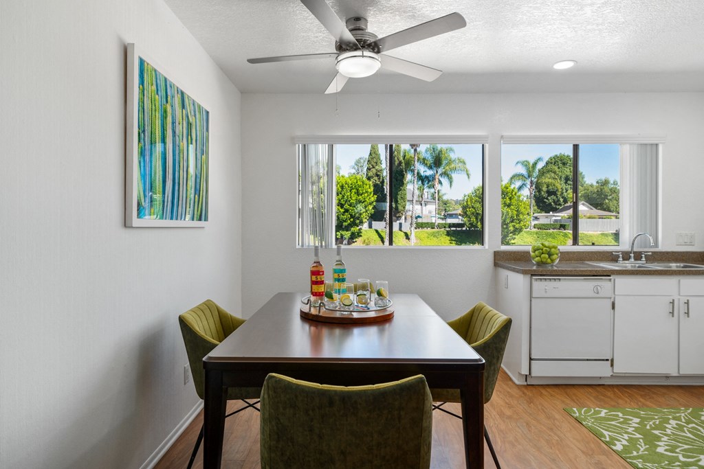 a dining room with a table and chairs and a ceiling fan