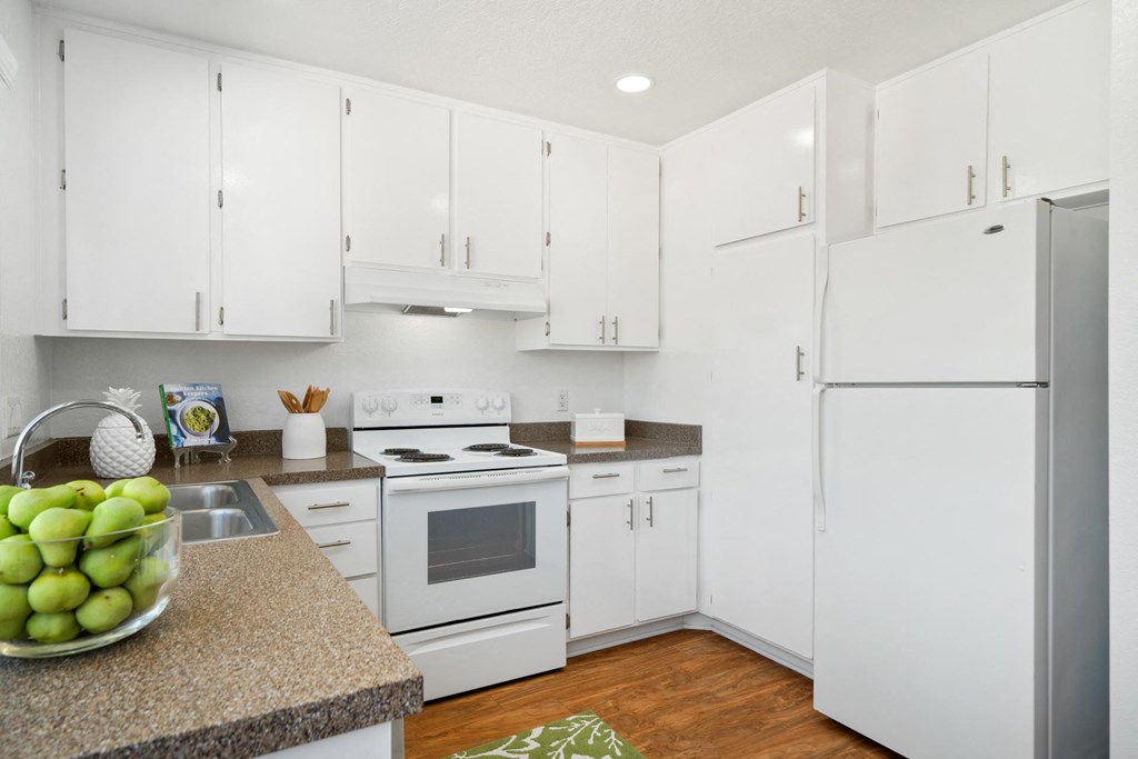 a white kitchen with white appliances and white cabinets