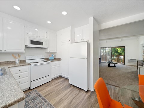 a kitchen with white appliances and white cabinets