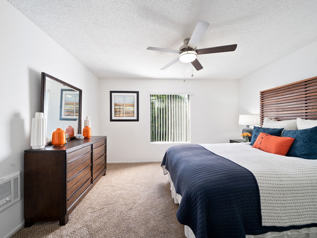 a bedroom with a large bed and a ceiling fan