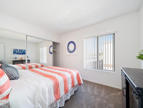 a bedroom with two beds and a dresser