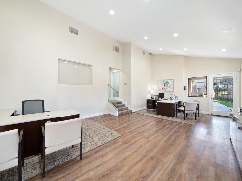 a room with hardwood floors and white walls