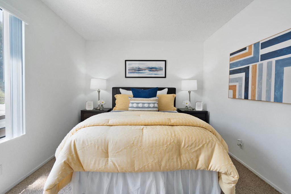 a bedroom with a bed and a large window