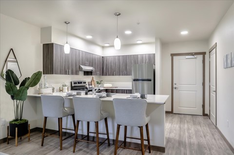 A modern kitchen with a dining table and chairs.