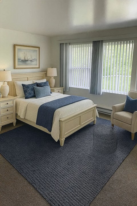 A bedroom with a bed, chair, and a painting on the wall.