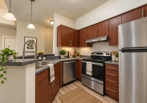 A modern kitchen with wooden cabinets and stainless steel appliances.