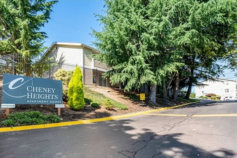 A sign for Cheney Heights Apartment Homes is in front of a building.