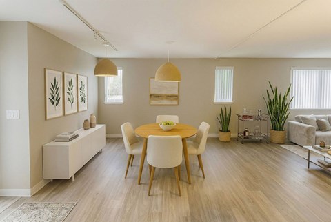 A dining room with a table and chairs.